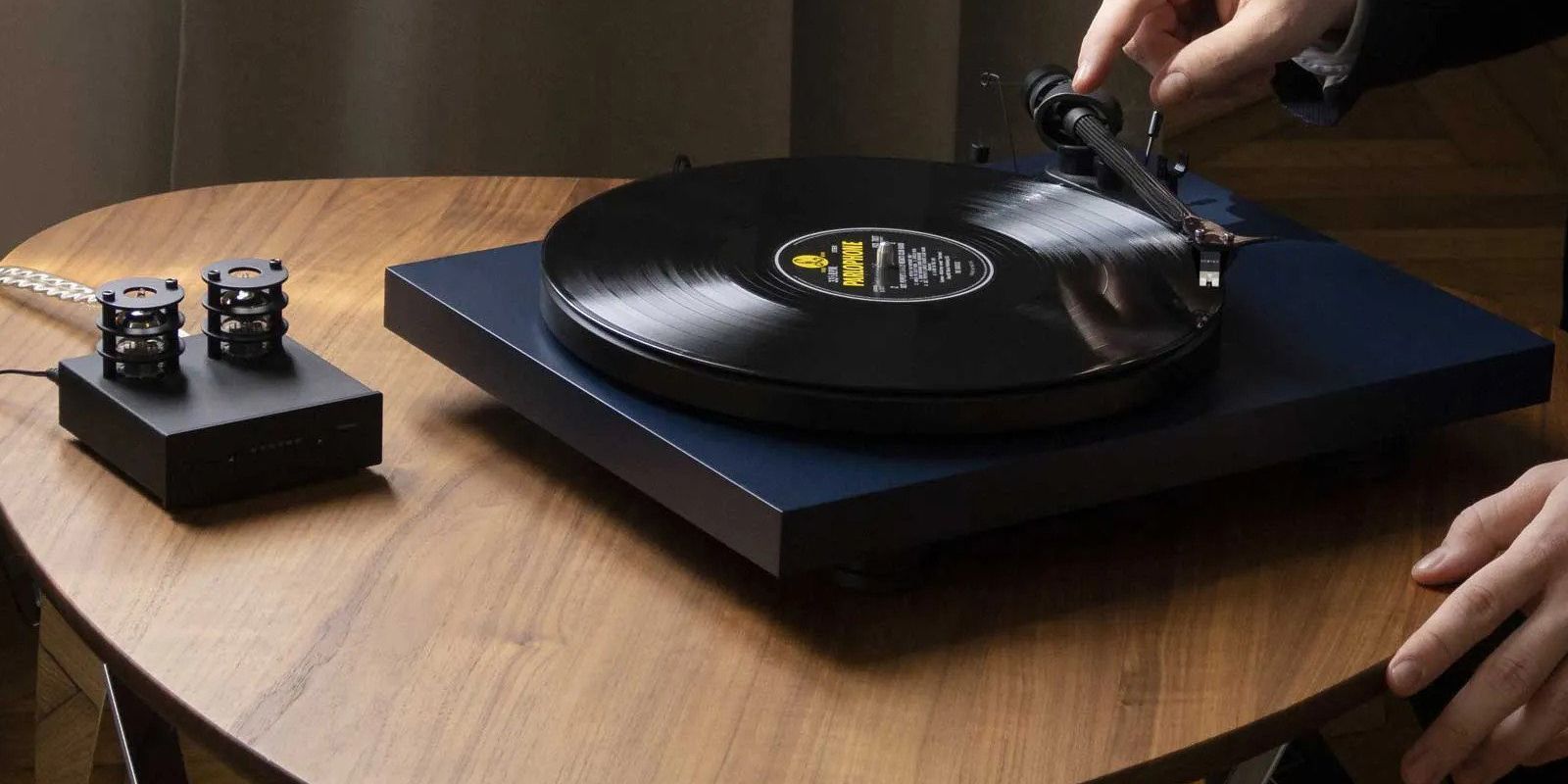 Parlophone Hi-Fi turntable on table adjusting tonearm 
