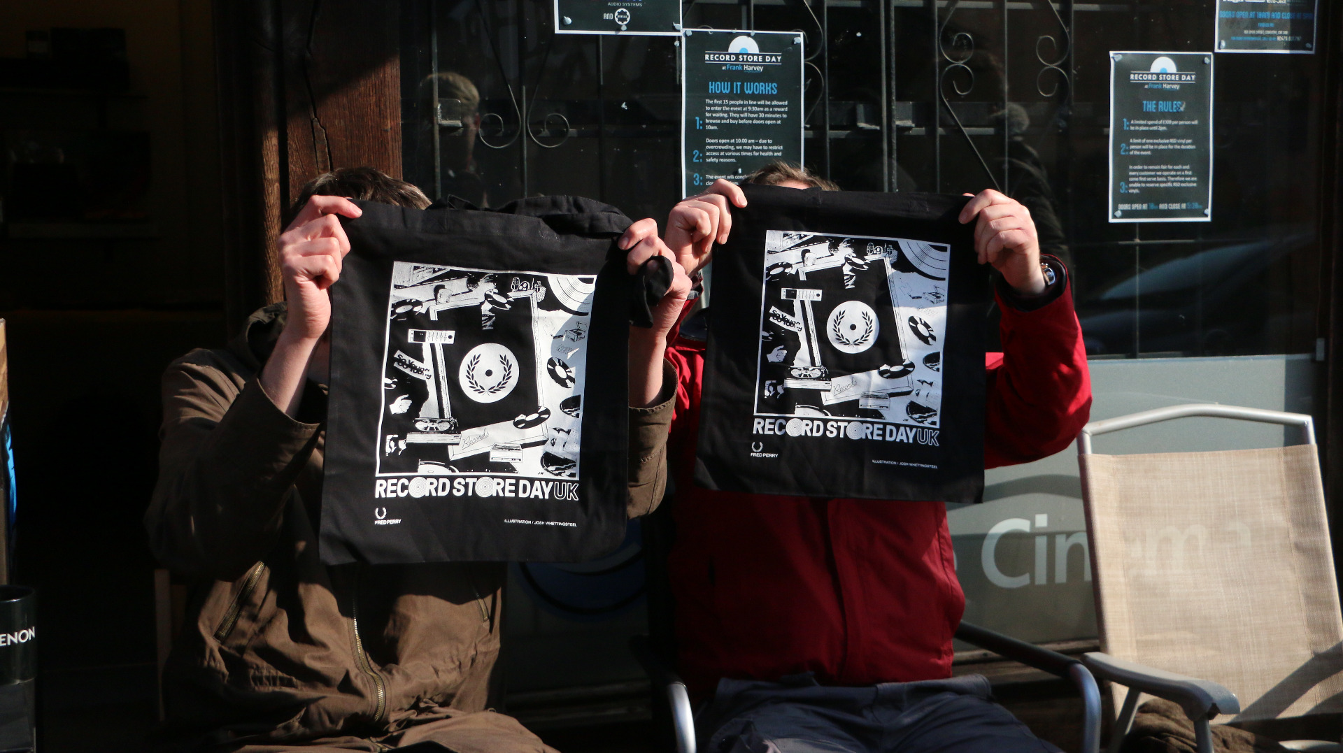 two people holding up tshirts of the 10th record store day UK