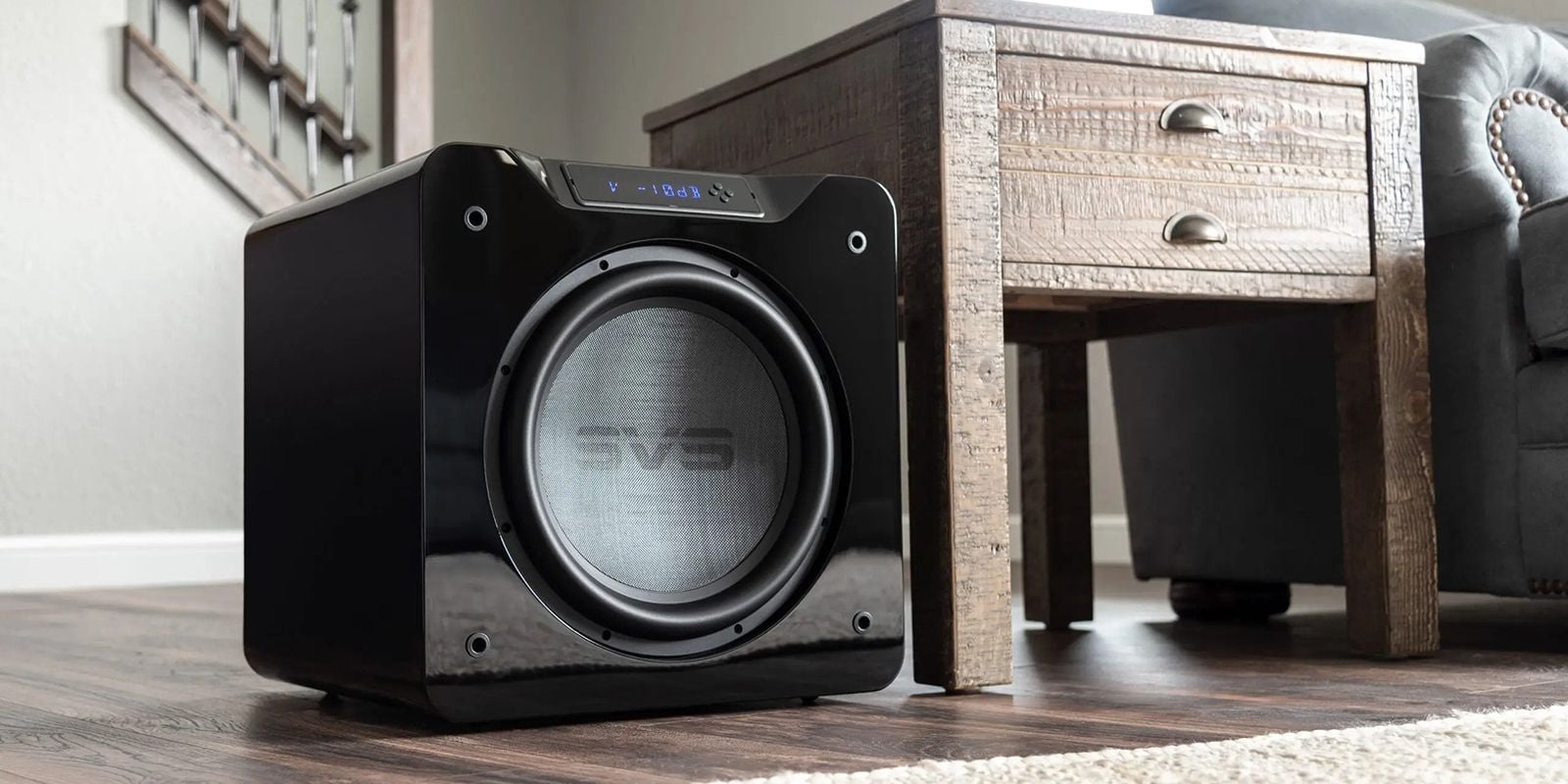 An SVS subwoofer next to a small side table in a living room
